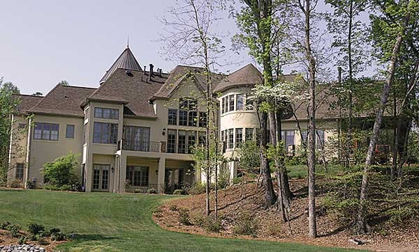 House plan exterior shows a multi-story home with a conical turret, multiple gables, bay windows, and a balcony.