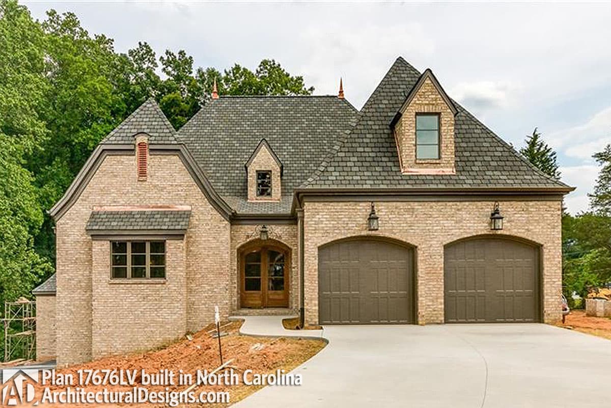 House plan exterior with a brick facade, multiple gables, dormer windows, and a double garage.