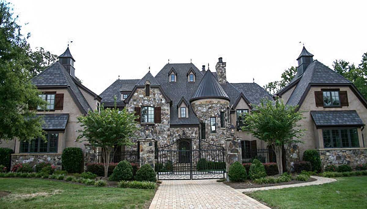 House plan exterior: Chateau-style with stone facade, multiple gables, turrets, and dormers.