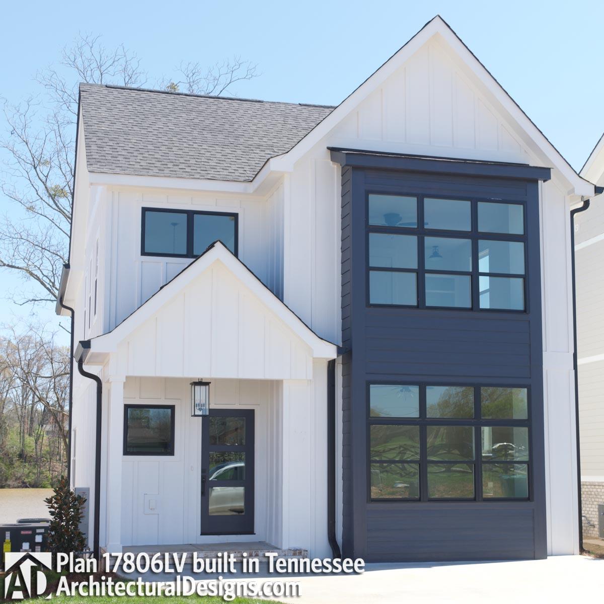 Modern Farmhouse house plan exterior, two stories, prominent gabled entrance, dark paneling with large windows.