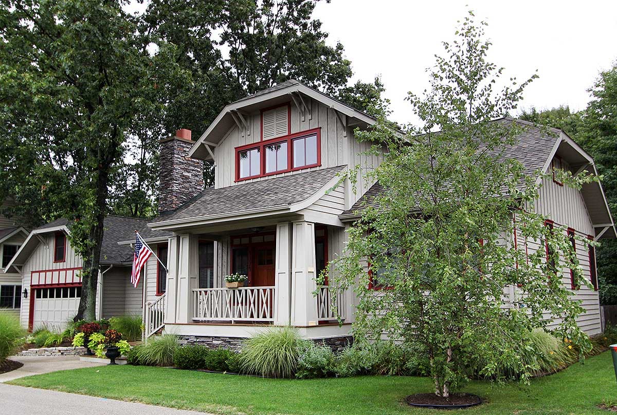 Craftsman style house plan exterior with stone chimney, covered porch, gable dormers, and red trim.