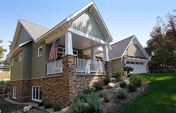 House plan exterior with stone base, covered porch with columns, gabled rooflines, and attached garage.