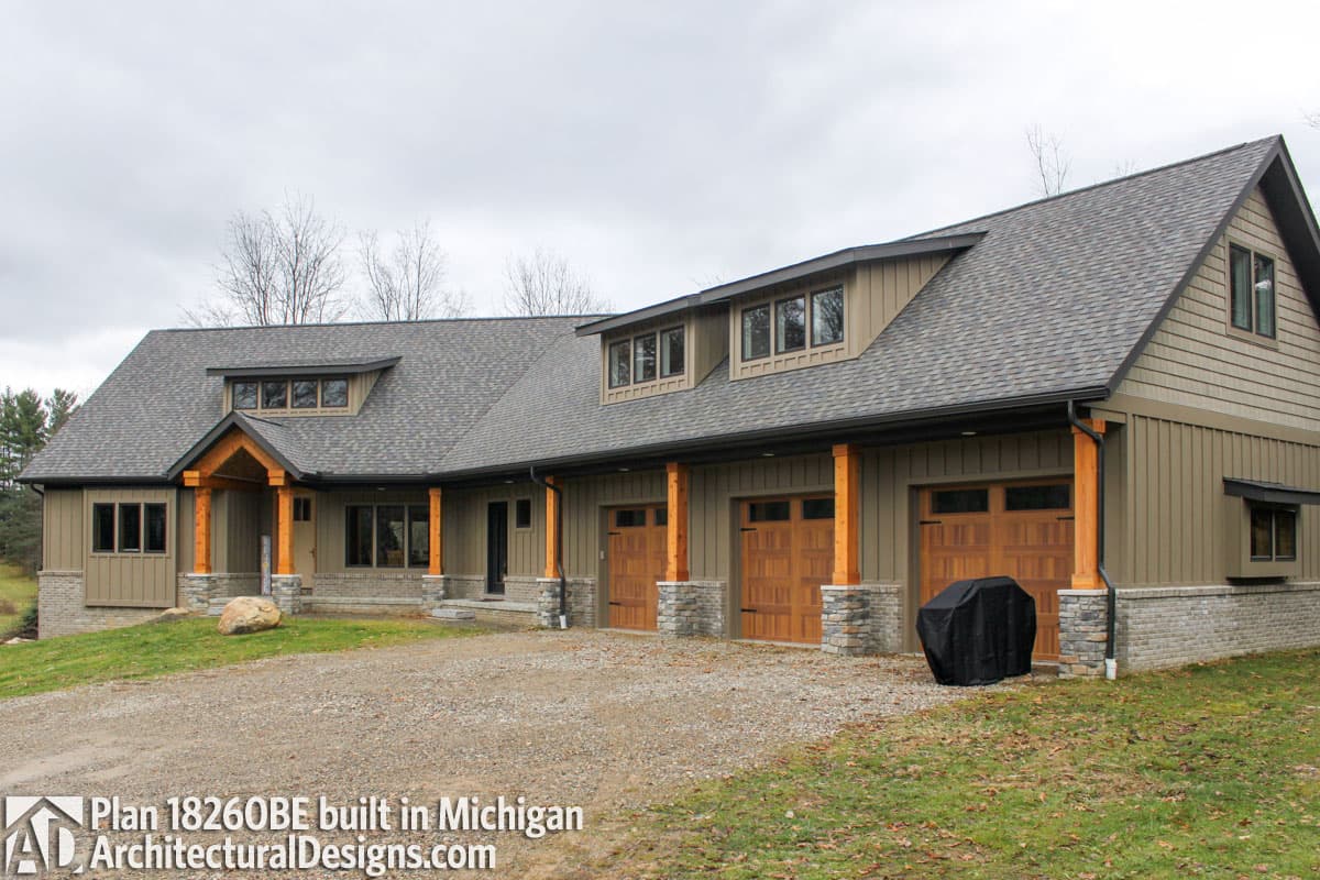 House plan exterior shows a multi-story home with a three-car garage, covered entryway with timber posts, and dormer windows.