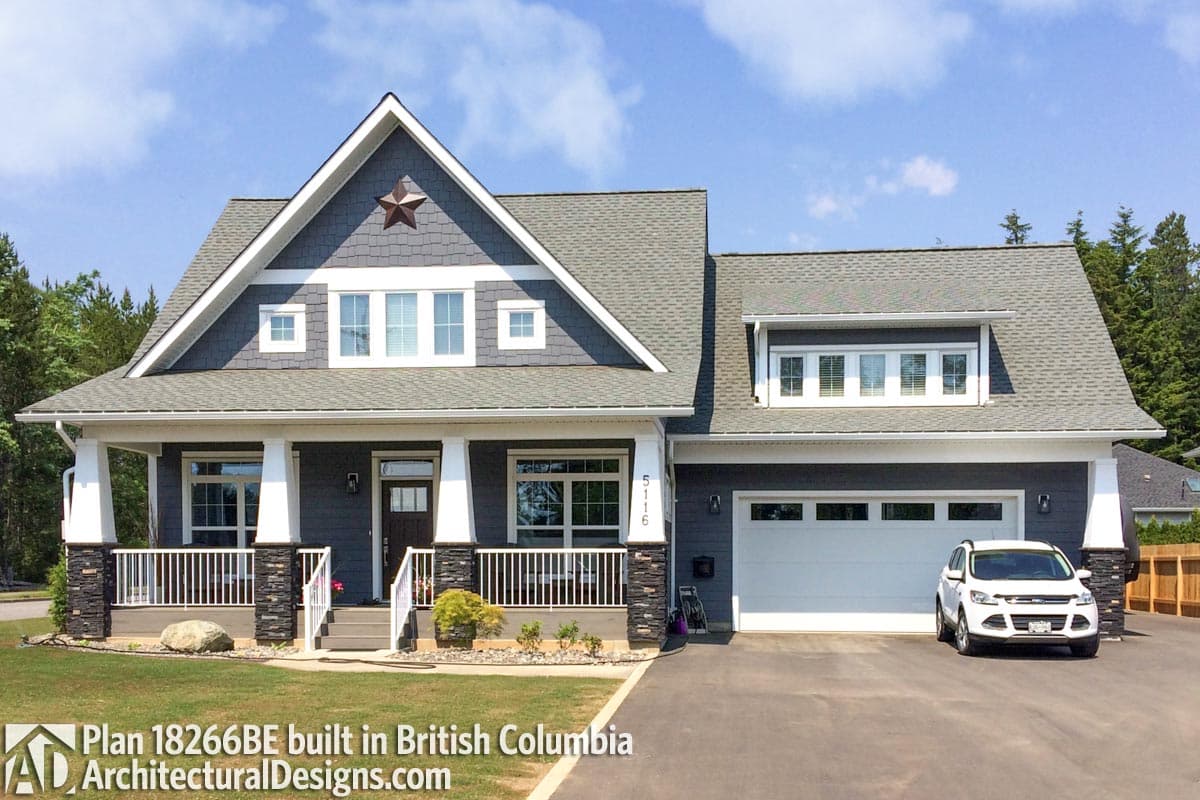 House plan exterior: Modern Farmhouse style, two stories, front porch with stone accents, gables with dormers, and attached garage.