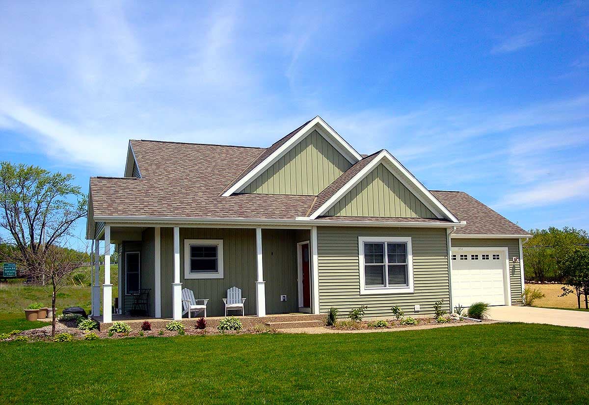 House plan exterior: One-story Modern Farmhouse with covered front porch, gabled dormers, and attached garage.
