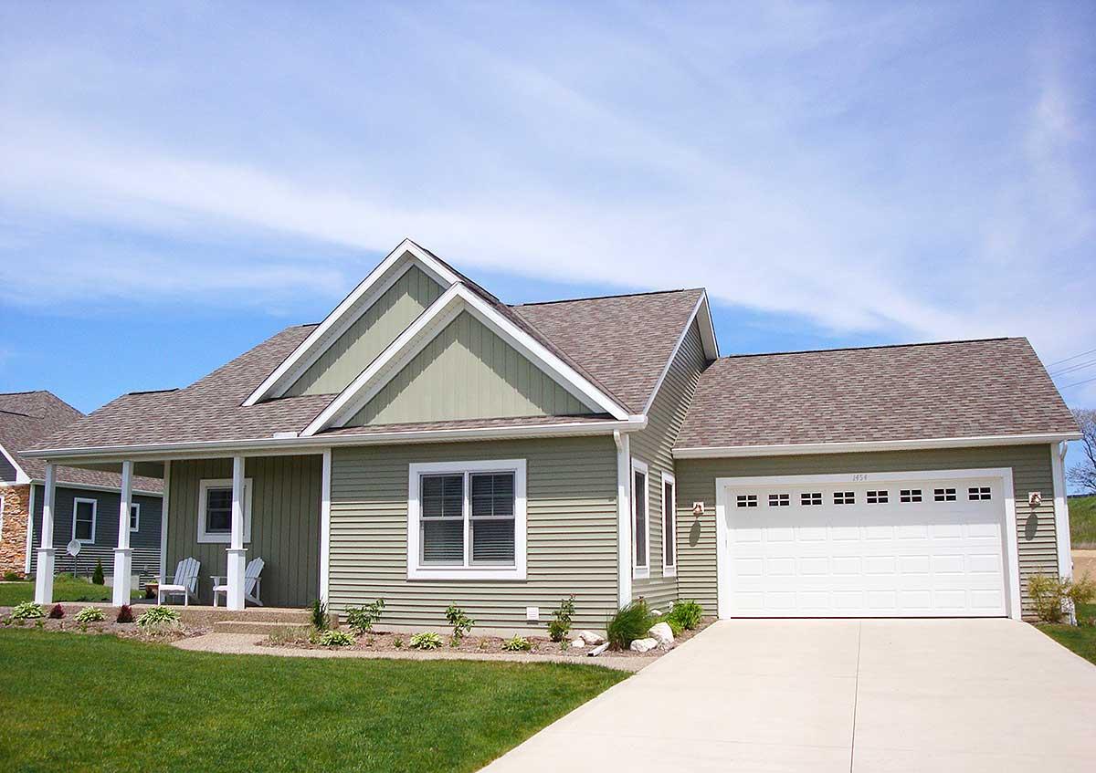 House plan exterior: One-story Modern Farmhouse with covered porch, gabled rooflines, and attached two-car garage.
