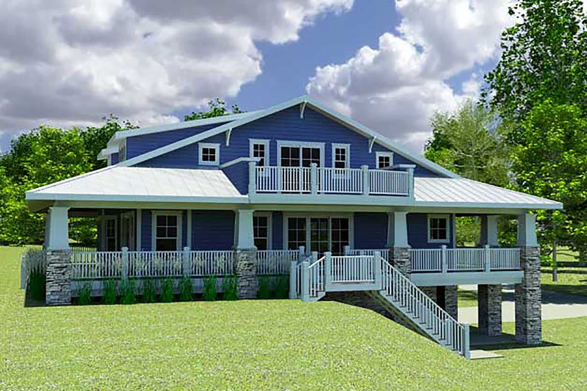 House plan exterior: two-story blue home with wrap-around porch, stone accents, second-level balcony, and metal roof.