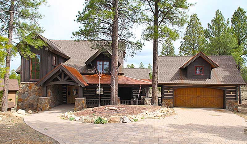 Log cabin house plan exterior with stone base, covered entrance, and attached garage with wooden door. Two stories visible.