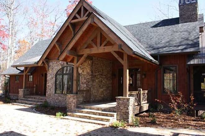 House plan exterior with stone accents, a covered entry with timber framing, and a prominent gable.