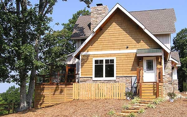 House plan exterior with wood siding, stone base, front porch, and stone chimney.