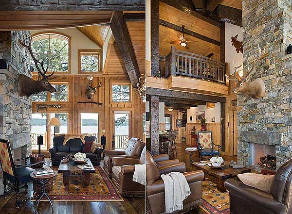 Interior view of a rustic living room with stone fireplace, vaulted wood ceiling, exposed beams, loft balcony, and large windows.