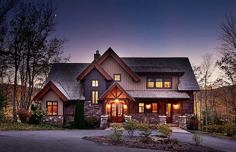 House plan exterior, Rustic style, two stories, stone base, prominent gables, covered entry with timber framing.