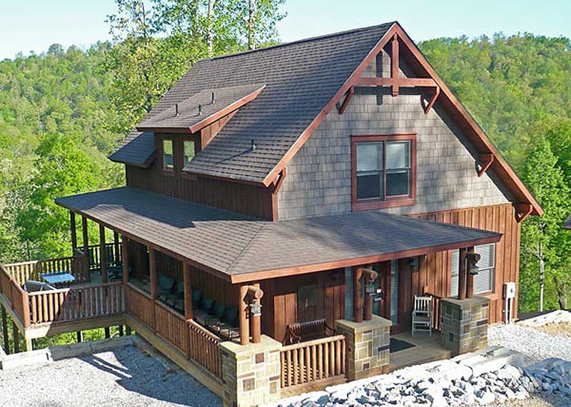 Craftsman-style house plan exterior with full-wrap porch, timber gable accents, and shingle siding.