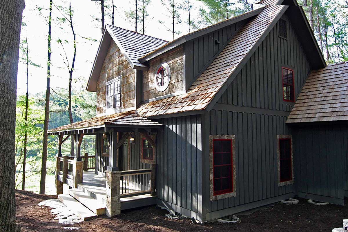 House plan exterior: two-story mountain style home with a wraparound porch, cedar shakes, and board-and-batten siding.