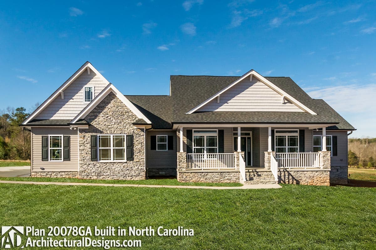 House plan exterior: Single-story Modern Farmhouse with stone accents, gables, and a covered front porch supported by stone-clad columns.