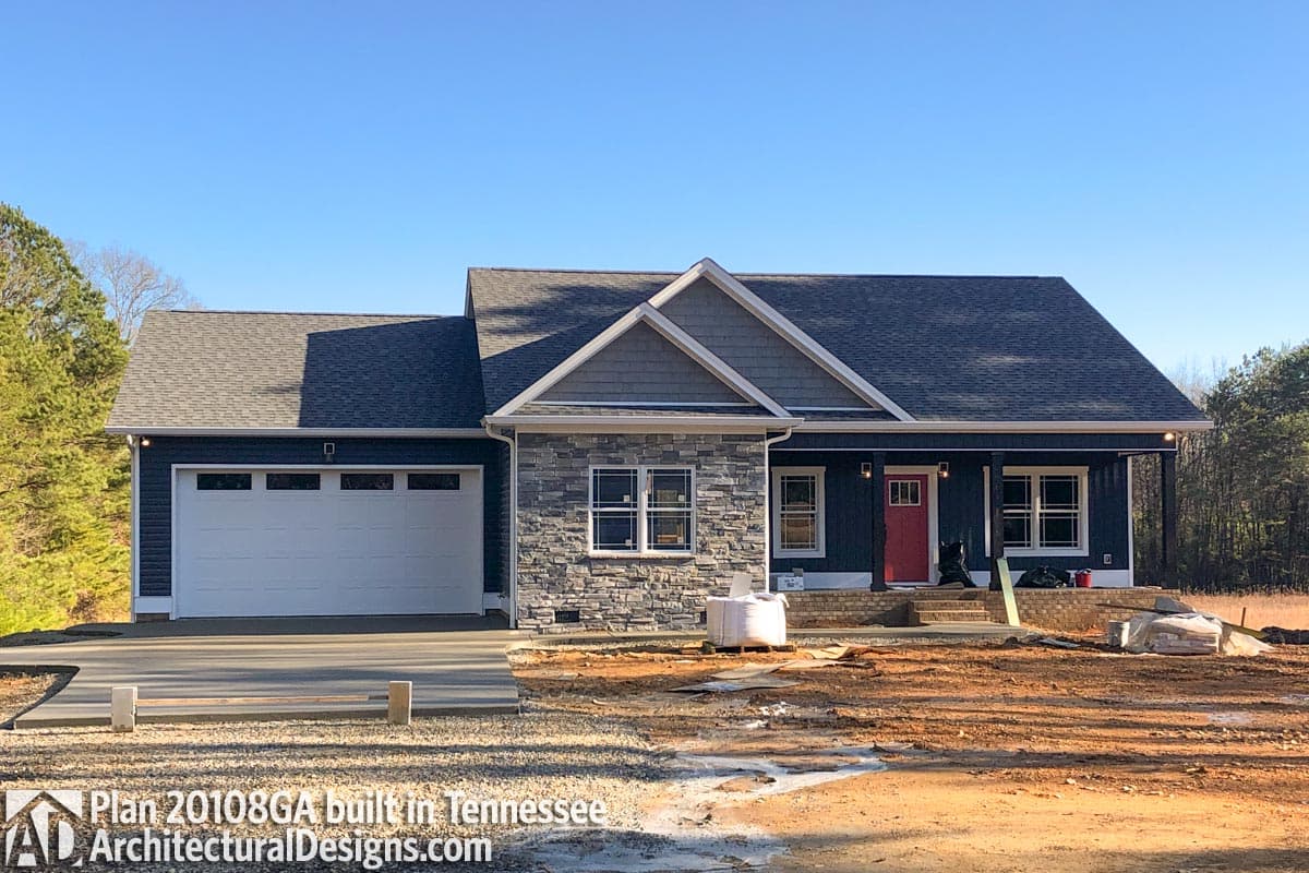 One-story house plan exterior with attached garage, stone facade, gabled dormer, and covered front porch.