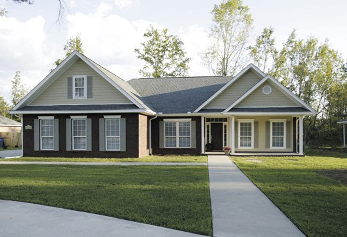 House plan exterior: single-story home with brick lower half, gabled dormer, and covered front porch.