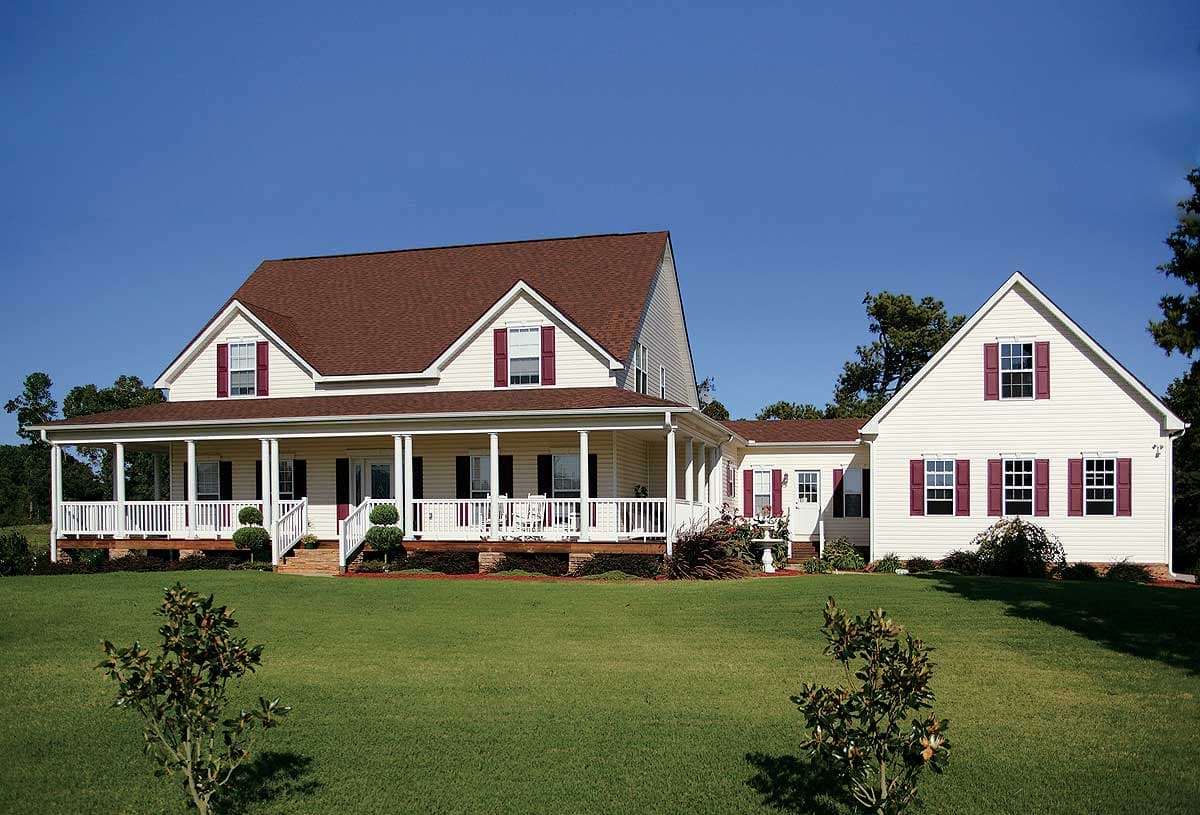 House plan exterior: Two-story Traditional style home with wraparound porch, gables, and attached garage.