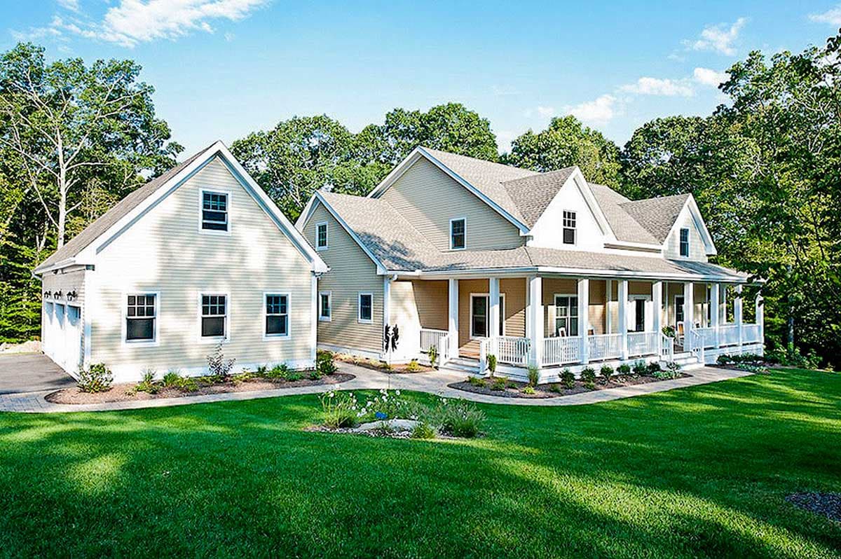 House plan exterior. Two-story home with a wraparound porch, gabled roof, and attached garage. Includes dormers and white trim details.