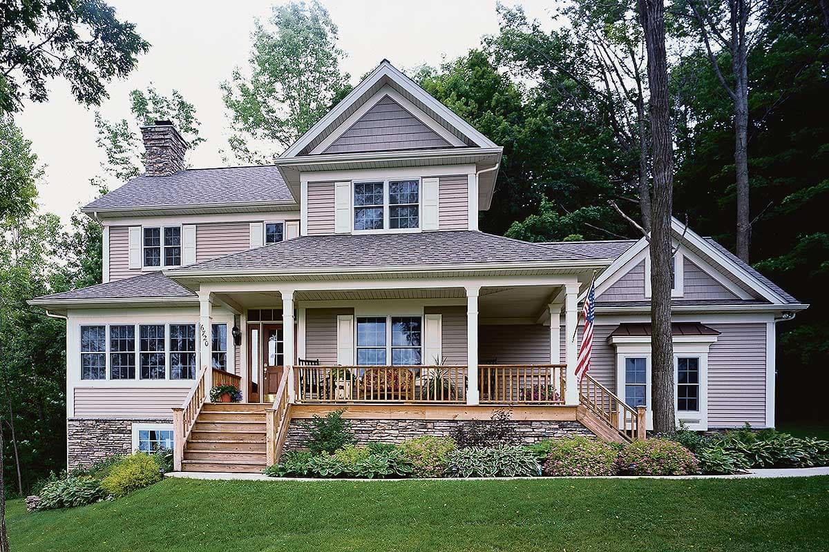 House plan exterior. Two-story house with a gabled roof, stone-clad foundation, and covered porch with pillars. Includes dormers and a chimney.