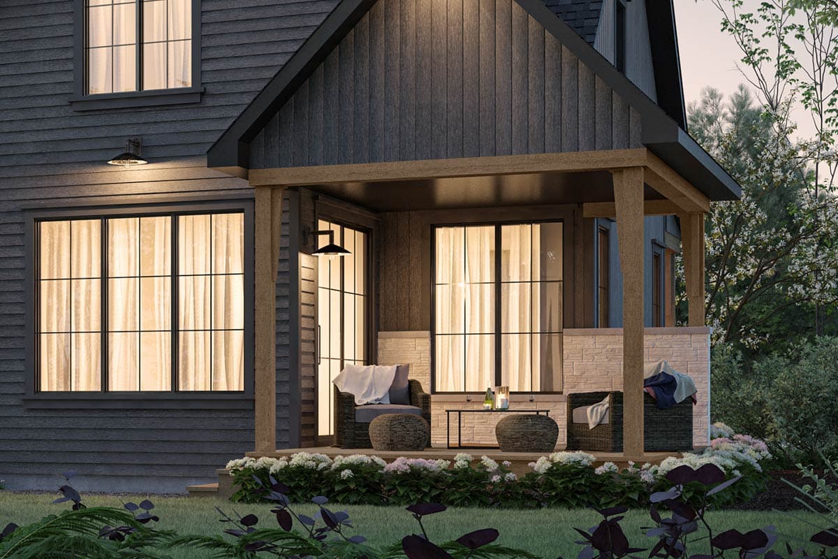 House plan exterior: Yellow two-story home with gabled front, covered porch with decorative posts, and attached garage.