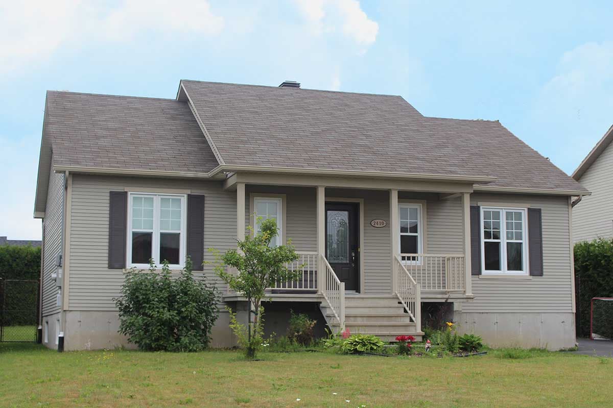 House plan exterior: Gable roof, covered porch with steps, siding, and multi-pane windows.