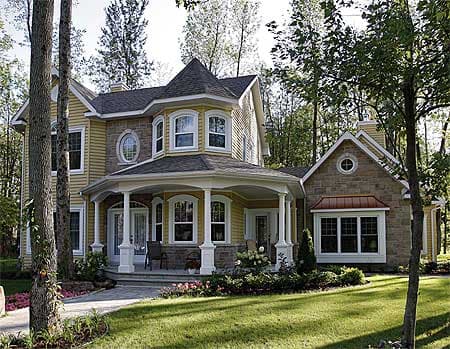 Two-story house plan exterior with stone and siding, wrap-around porch, bay windows, and turret.