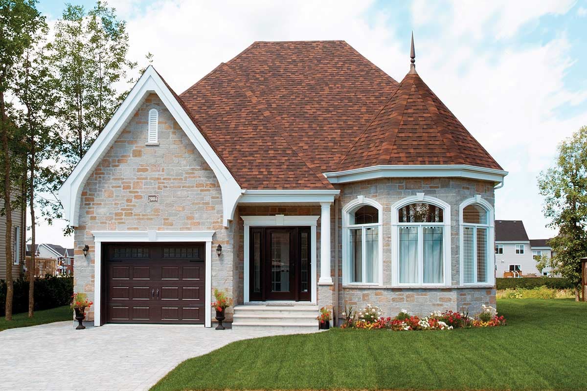 House plan exterior featuring stone facade, prominent gable with decorative vent, attached garage, and turret with arched windows.