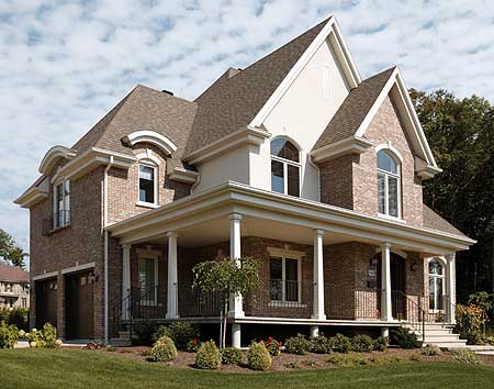 House plan exterior: Two-story brick home with a wrap-around porch, dormer windows, and a prominent gable.