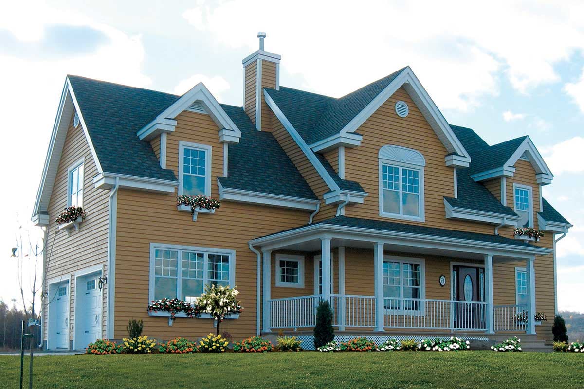 House plan exterior featuring a two-story dwelling with a wraparound porch, dormers, gables, and a side-facing two-car garage.