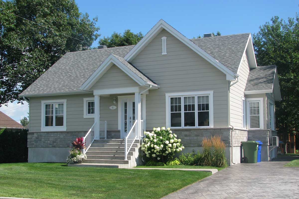 House plan exterior: Two-story home with a covered front porch, gabled rooflines, and stone and horizontal siding.