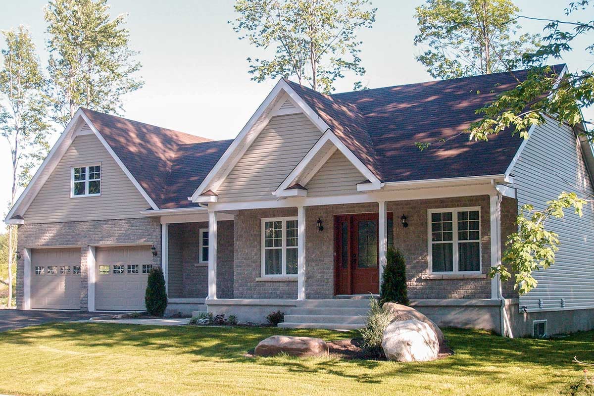 House plan exterior: One-story Modern Farmhouse with a covered front porch, gable rooflines, and a double garage.