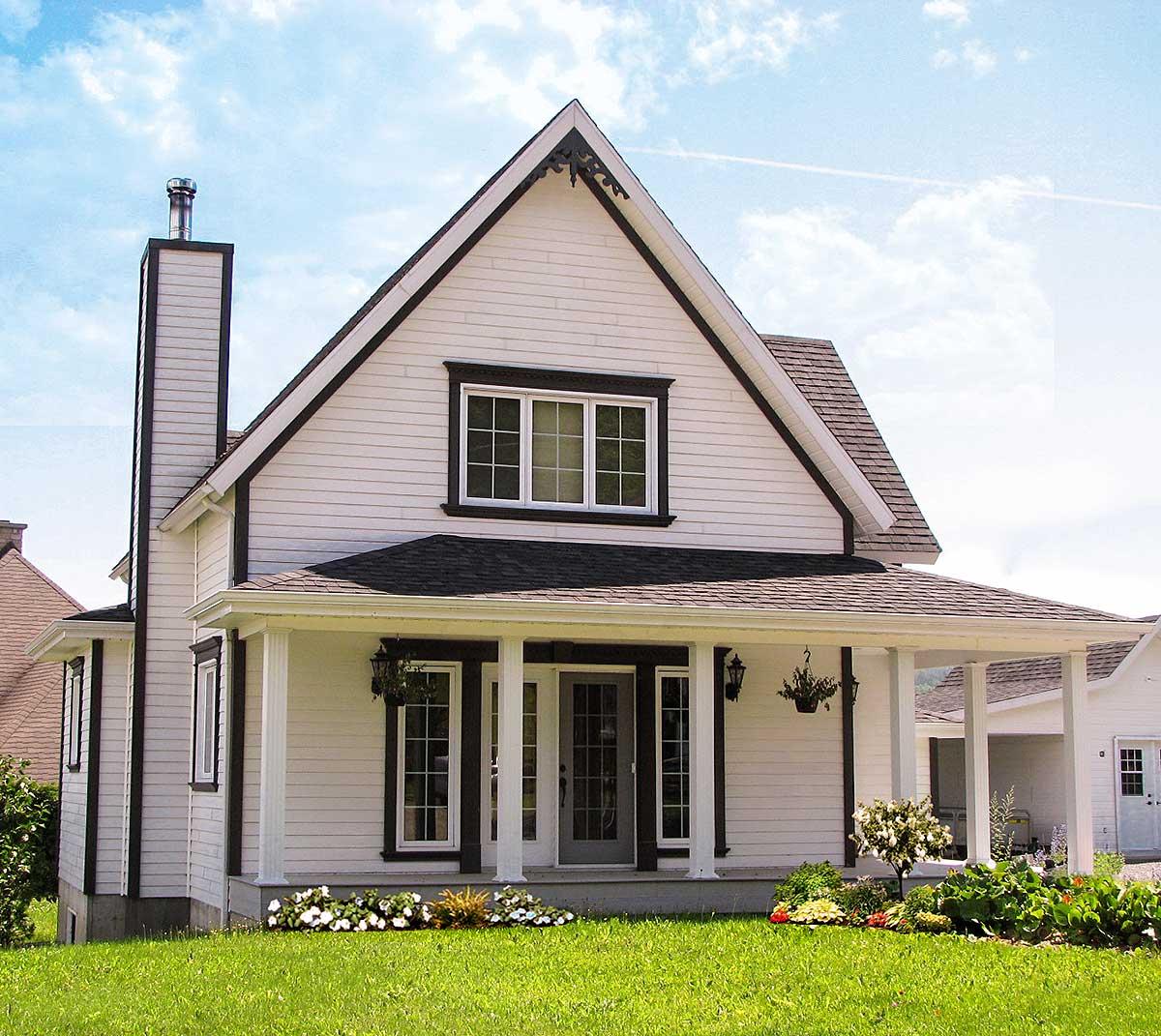 House plan exterior: two-story white house with a covered porch, prominent chimney, gables, and dark trim.