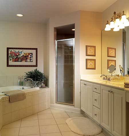 Bathroom with corner tub, glass-enclosed shower, and double vanity with white cabinetry.