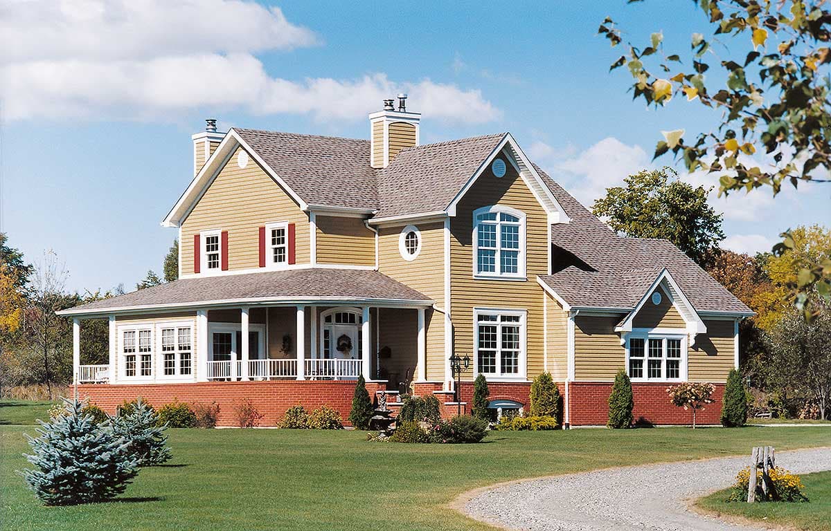 House plan exterior: Two-story home with wrap-around porch, gables, and beige siding.