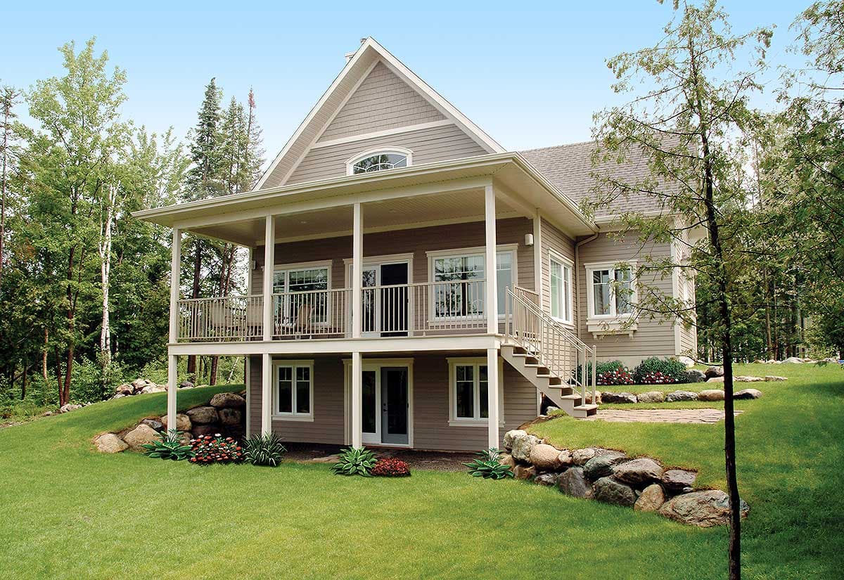 House plan exterior: Two-story dwelling with a covered wrap-around porch, gabled dormer, and tiered foundation.