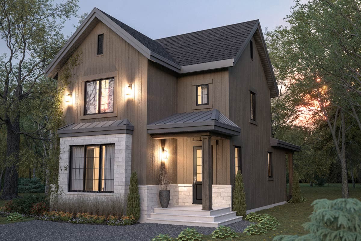 A modern two-story home with dark siding, a white brick base, and a covered front porch. Lit by outdoor lights, set amongst trees.