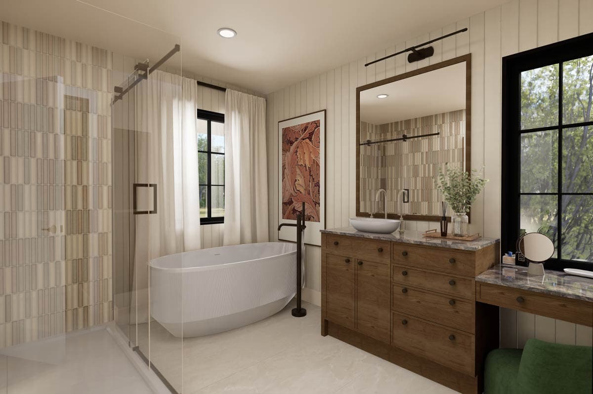 A modern bathroom features a freestanding tub, large vanity with a vessel sink, and an abstract artwork above the faucet.
