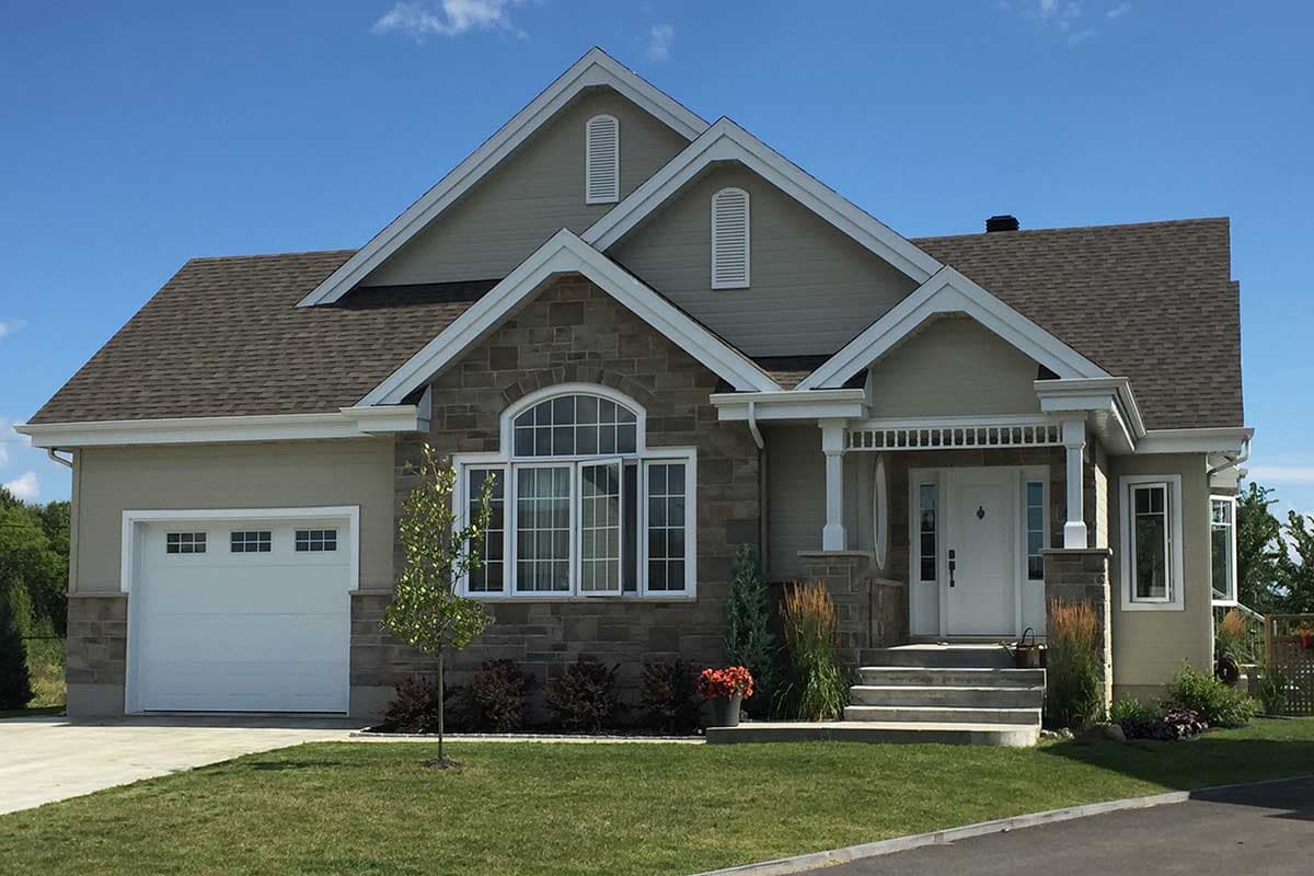 House plan exterior: One-story home with attached garage, stone facade, arched window, and covered porch with white columns.