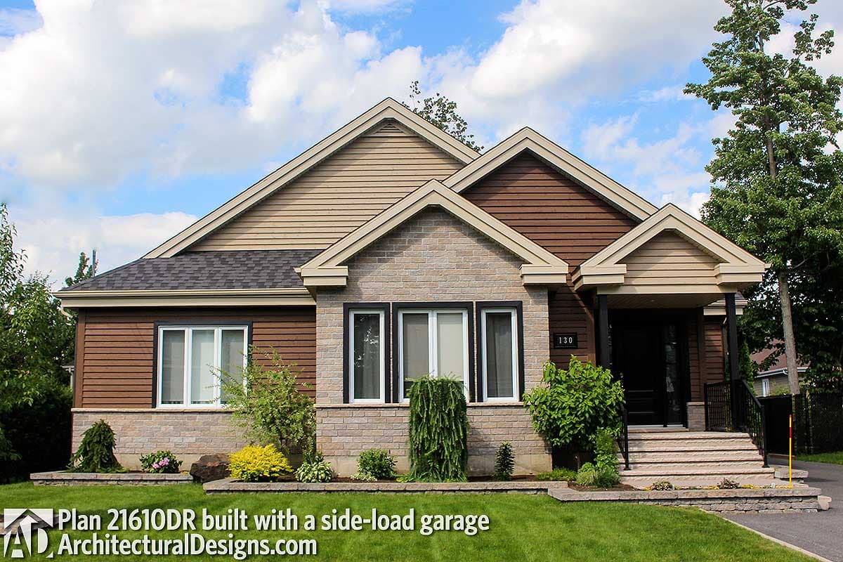 House plan exterior: One-story home with gabled rooflines, stone and wood siding, and a covered front entrance with side-load garage.