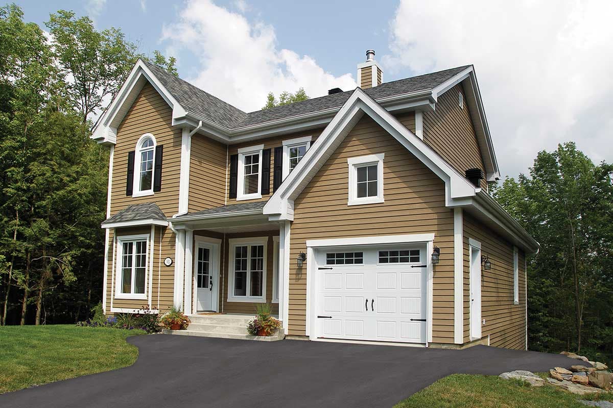 House plan exterior, two stories, with gabled dormers, arched window, covered entry, and attached garage.