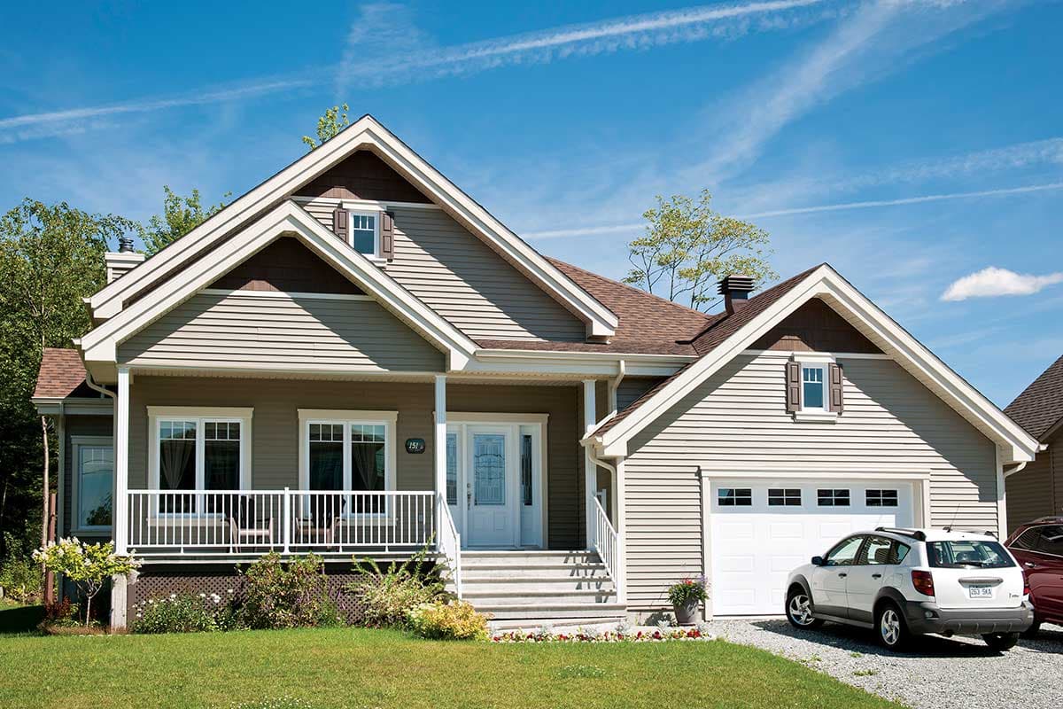 House plan exterior: Two-story Modern Farmhouse with gabled dormers, a covered front porch, and an attached two-car garage.