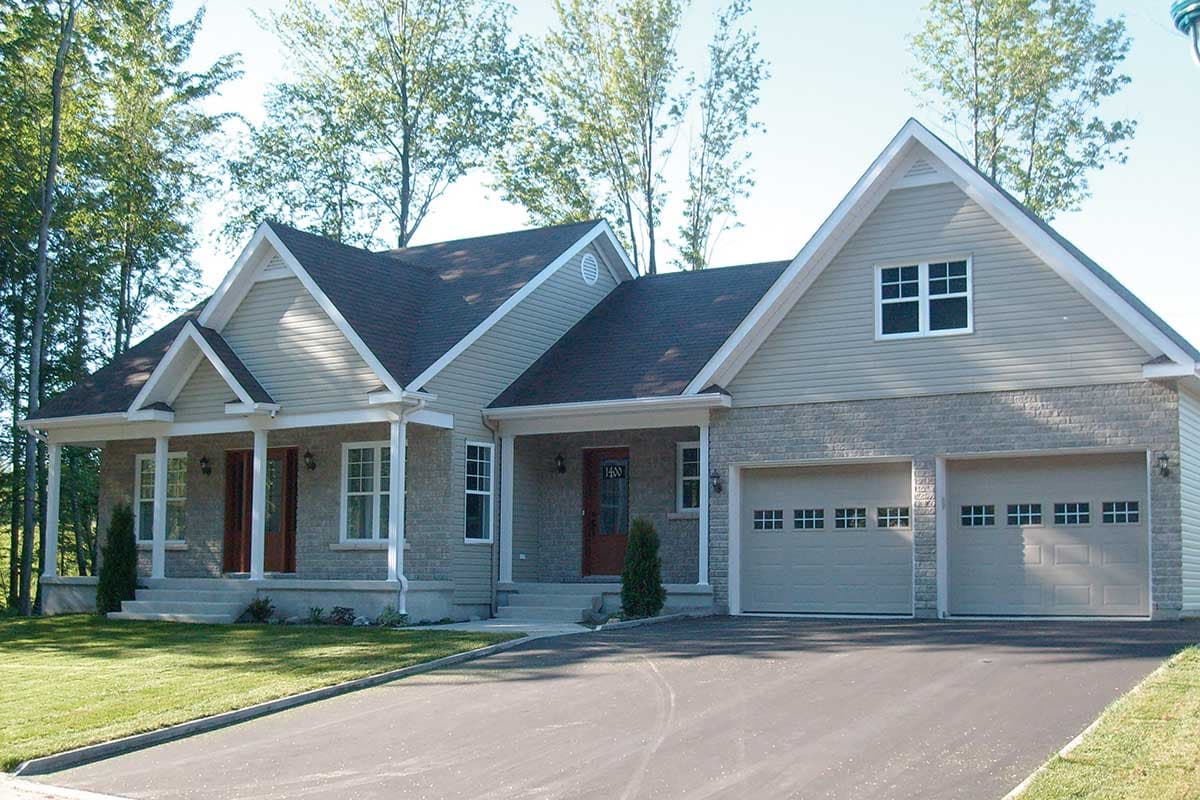 House plan exterior: Ranch style, single story, featuring a full-width covered porch, multiple gables, and a double garage.