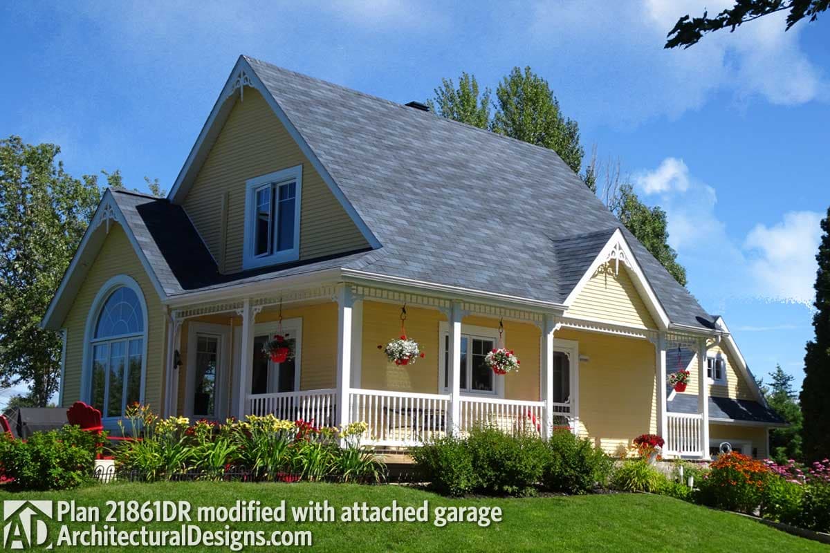 House plan exterior: two-story home with a wraparound porch, gables, dormers, and an arched window.