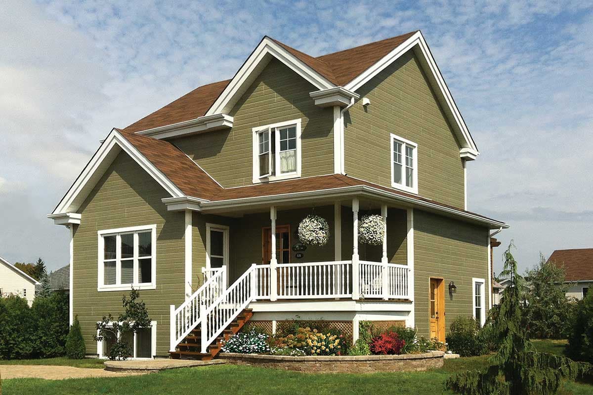 House plan exterior: Two-story home with covered front porch, prominent gables, and double-hung windows.