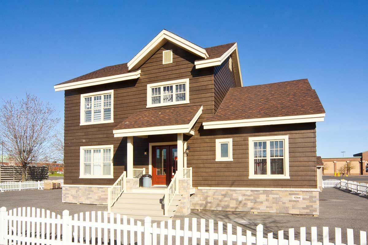 House plan exterior: Two-story home with brown horizontal siding, stone base, covered entry porch, and multiple gables.