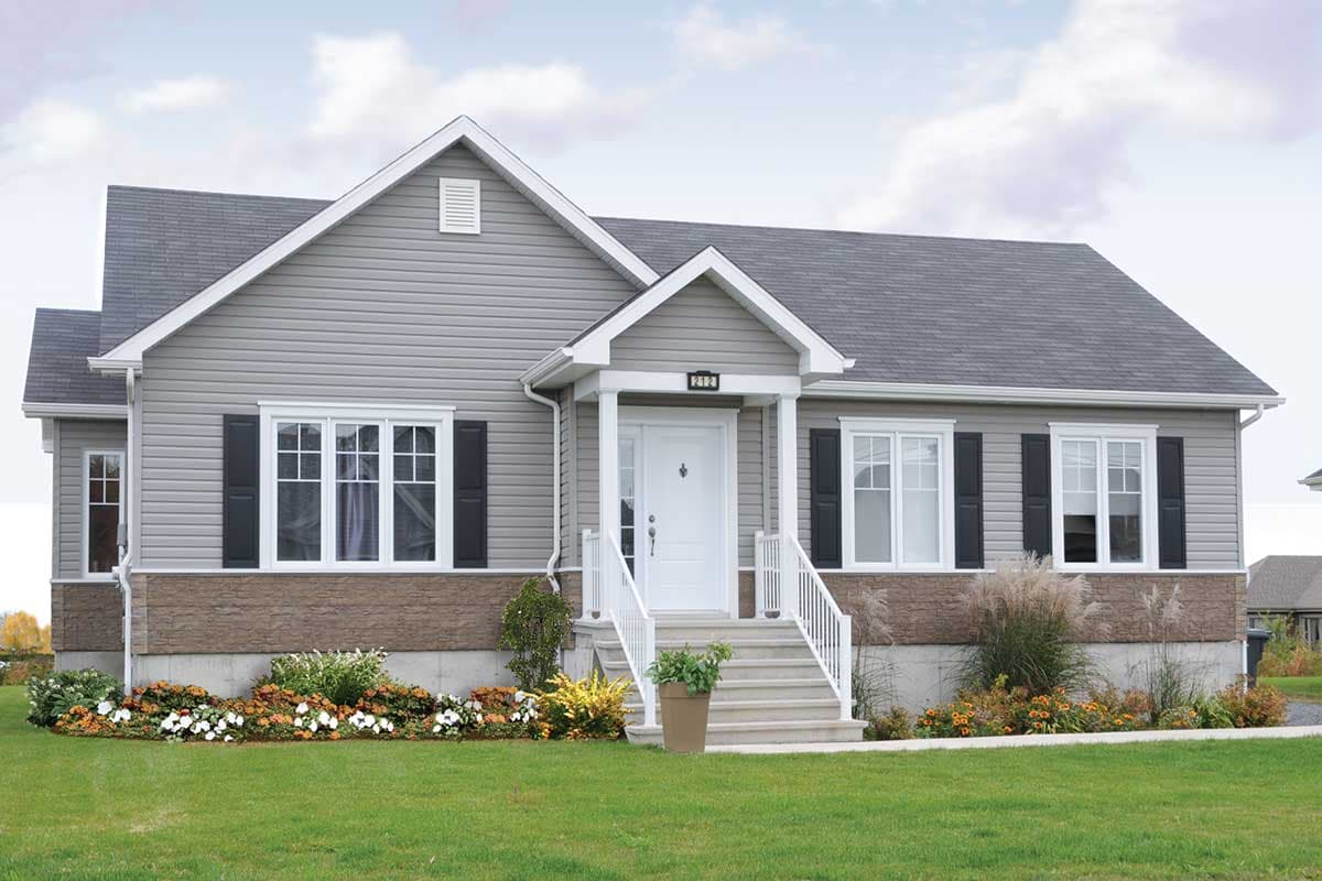 House plan exterior with gable roof, covered front porch, and black shutters. Features include a light-colored siding and stone veneer at the base.