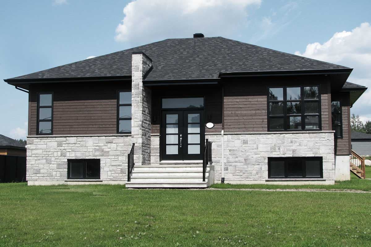 House plan exterior: Two-story home with stone base, horizontal siding, gable roof, and central double doors.