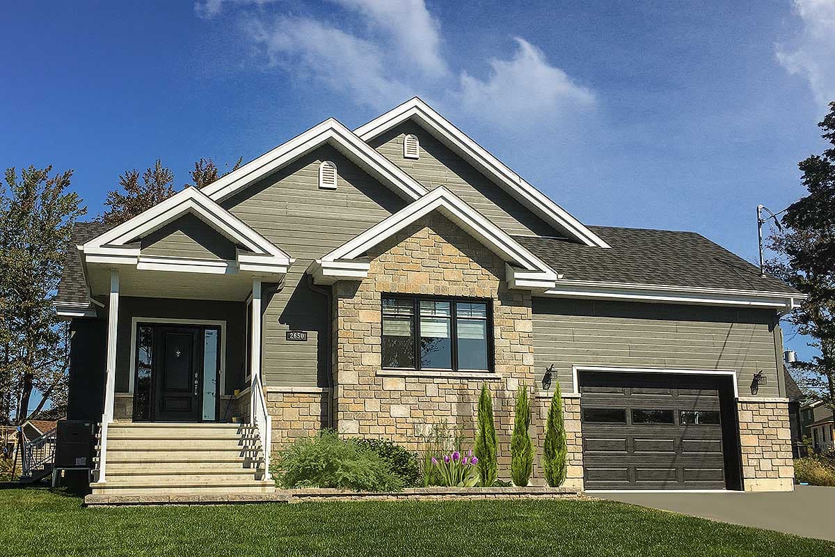 House plan exterior featuring stacked stone accents, covered porch, and attached garage with stone base.