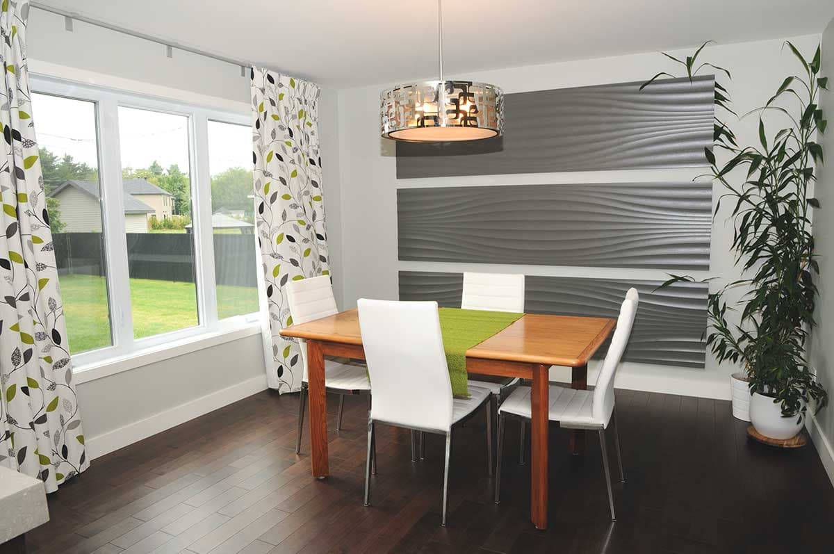 Dining room with wood table and chairs, large window, modern pendant light, and textured wall panels.